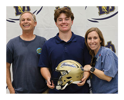 A man and two women pose for a photo with a football helmet. AI generated content