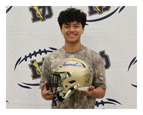 A young man wearing a football helmet and holding a football. AI generated content