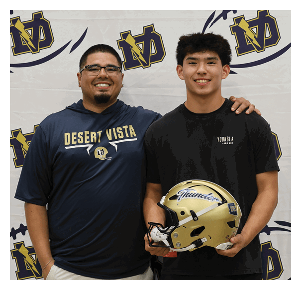 Two men pose with a football helmet, one of them holding it. AI generated content