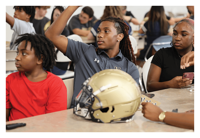 A group of people are sitting around a table with a football helmet on it. AI generated content