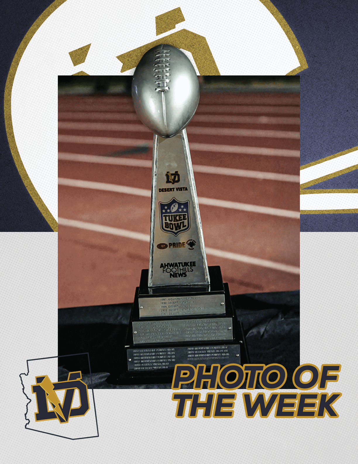 A silver football trophy with multiple engraved plaques is displayed on a black cloth with a logo and the text “PHOTO OF THE WEEK" in the bottom right corner. Description generated by AI