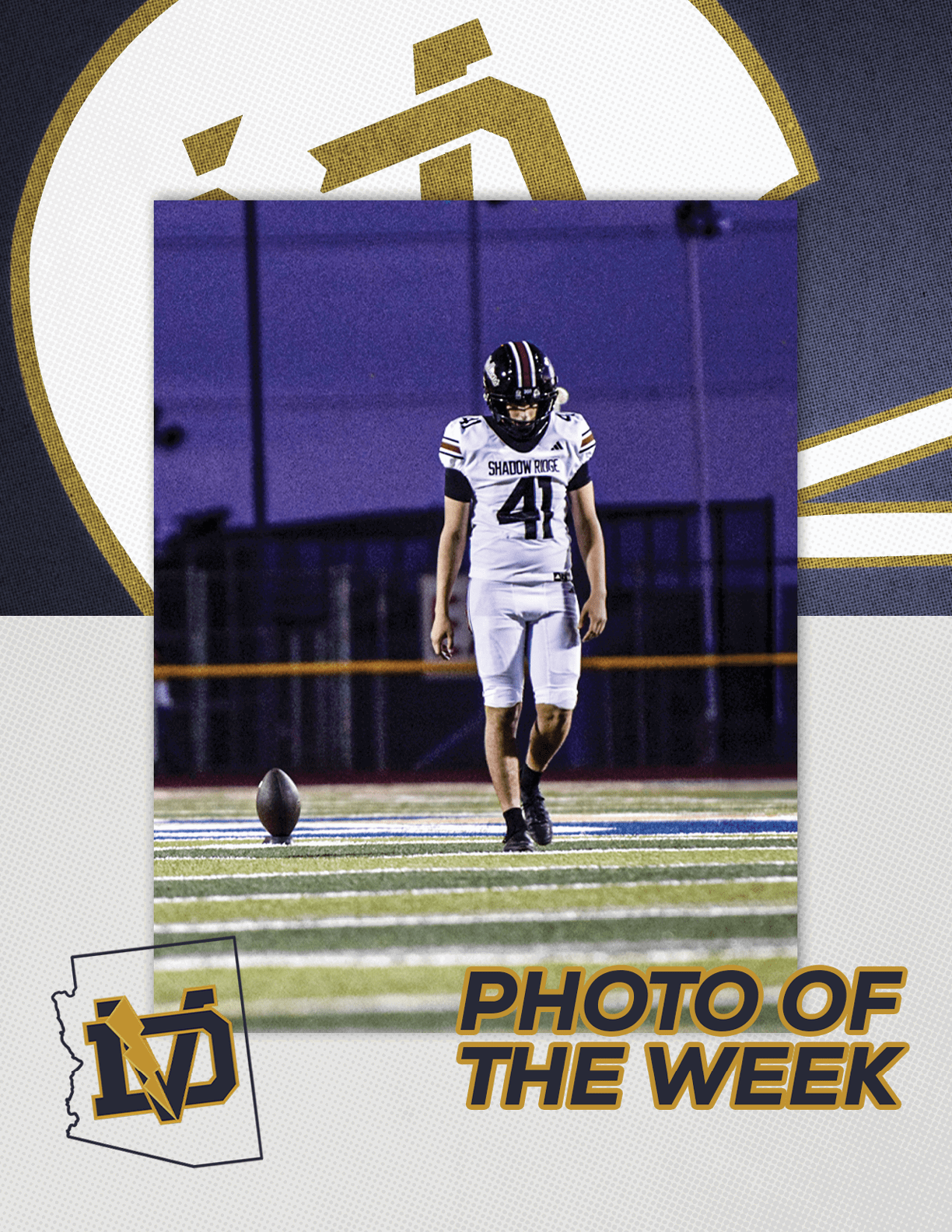 A person in a football uniform with the number 41 is walking on a field toward a football that is standing upright on the ground during a nighttime game. Description generated by AI