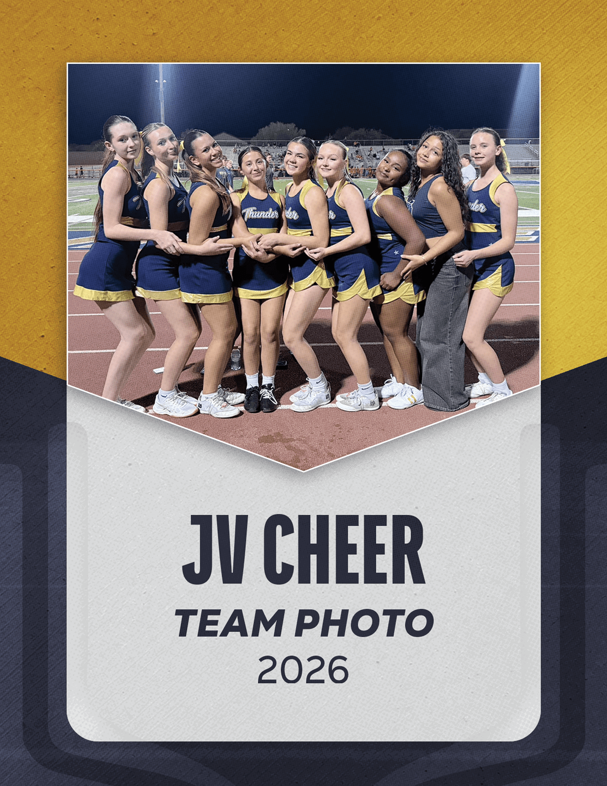 A group of nine people in cheerleading uniforms and one person in casual clothing stand closely together on a track field at night, posing for a team photo labeled JV Cheer Team Photo 2026. Description generated by AI