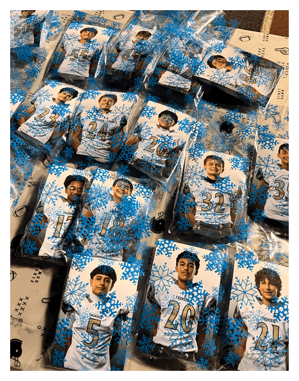 Multiple packaged cards featuring people wearing sports jerseys with numbers are arranged on a surface. Description generated by AI
