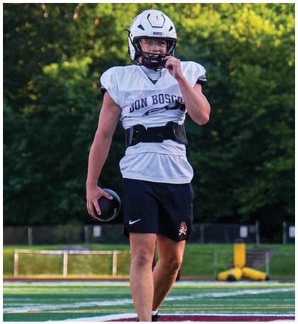 A football player wearing a blue and red jersey. Description generated by AI