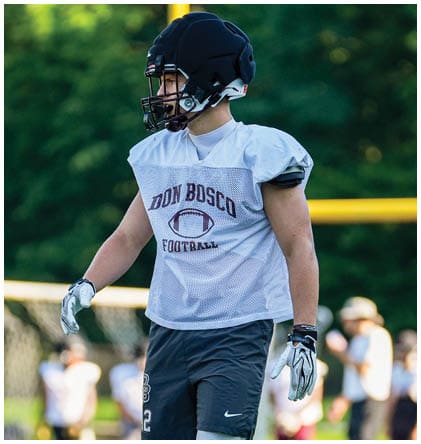 A football player wearing a blue and red jersey. Description generated by AI