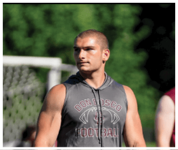 A football player wearing a blue and red jersey. Description generated by AI