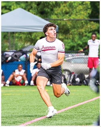 A football player wearing a blue and red jersey. Description generated by AI