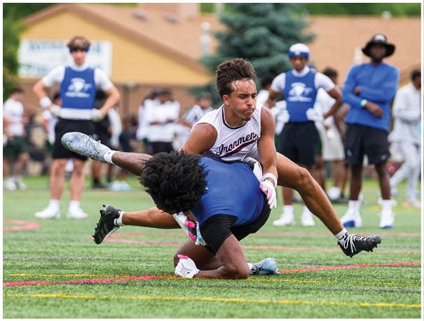 A football player wearing a blue and red jersey. Description generated by AI