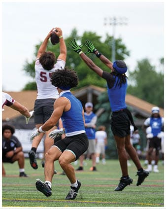 A football player wearing a blue and red jersey. Description generated by AI