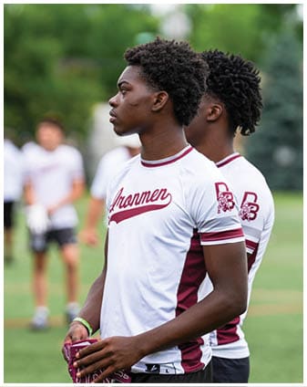 A football player wearing a blue and red jersey. Description generated by AI