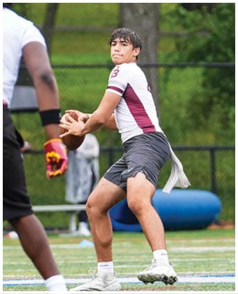 A football player wearing a blue and red jersey. Description generated by AI