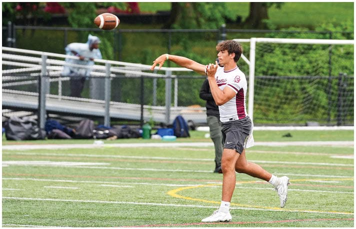 A football player wearing a blue and red jersey. Description generated by AI