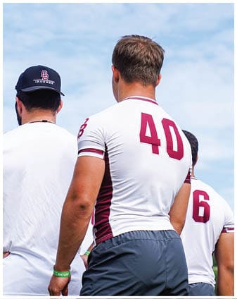 A football player wearing a blue and red jersey. Description generated by AI