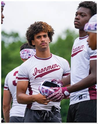 A football player wearing a blue and red jersey. Description generated by AI