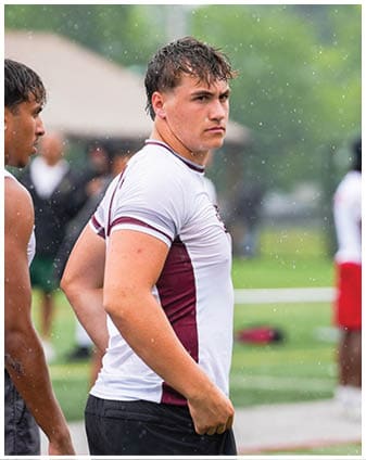 A football player wearing a blue and red jersey. Description generated by AI