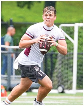 A football player wearing a blue and red jersey. Description generated by AI