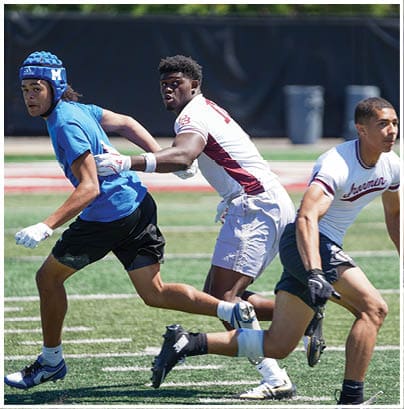 A football player wearing a blue and red jersey. Description generated by AI