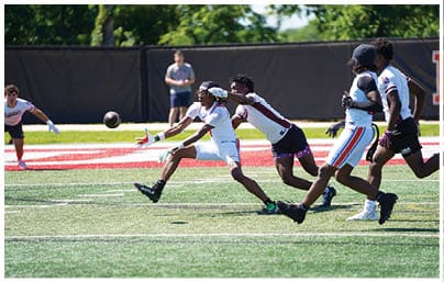 A football player wearing a blue and red jersey. Description generated by AI