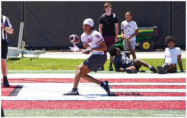 A football player wearing a blue and red jersey. Description generated by AI