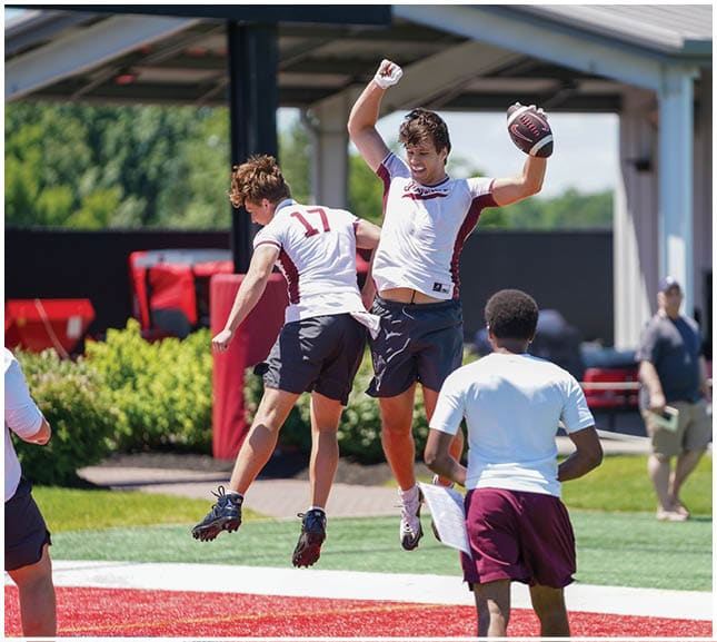 A football player wearing a blue and red jersey. Description generated by AI