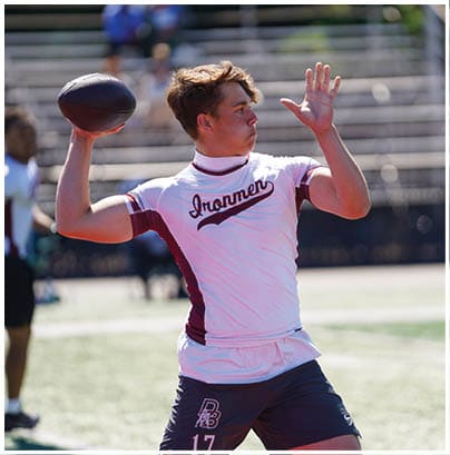 A football player wearing a blue and red jersey. Description generated by AI