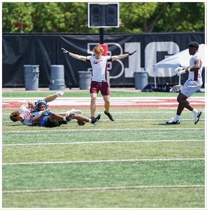 A football player wearing a blue and red jersey. Description generated by AI
