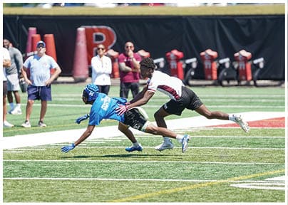 A football player wearing a blue and red jersey. Description generated by AI
