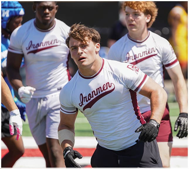 A football player wearing a blue and red jersey. Description generated by AI