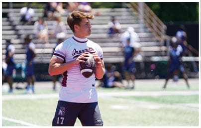 A football player wearing a blue and red jersey. Description generated by AI