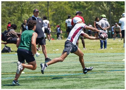 A football player wearing a blue and red jersey. Description generated by AI