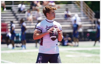 A football player wearing a blue and red jersey. Description generated by AI