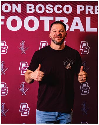 A football player wearing a blue and red jersey. Description generated by AI