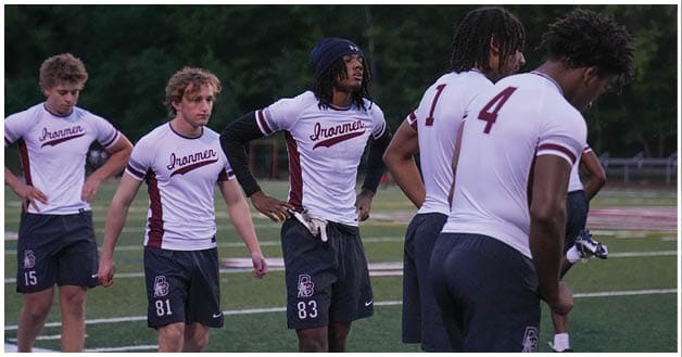 A football player wearing a blue and red jersey. Description generated by AI