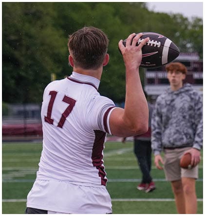 A football player wearing a blue and red jersey. Description generated by AI