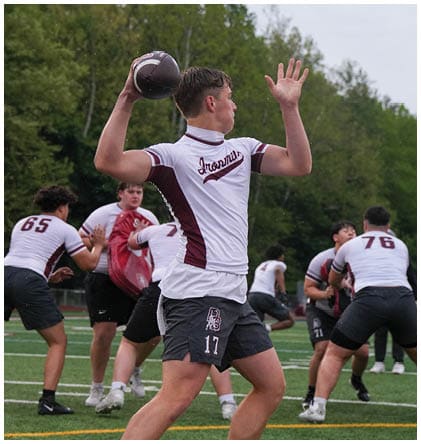 A football player wearing a blue and red jersey. Description generated by AI