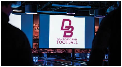 A football player wearing a blue and red jersey. Description generated by AI