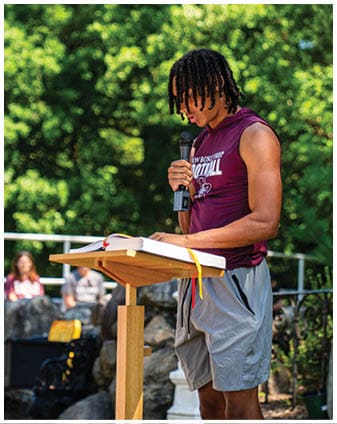 A football player wearing a blue and red jersey. Description generated by AI