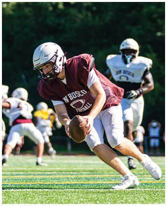 A football player wearing a blue and red jersey. Description generated by AI