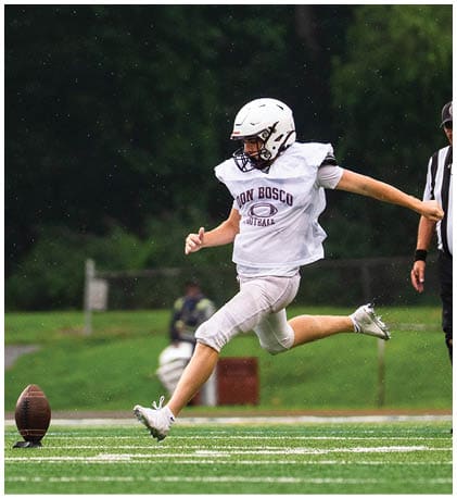 A football player wearing a blue and red jersey. Description generated by AI