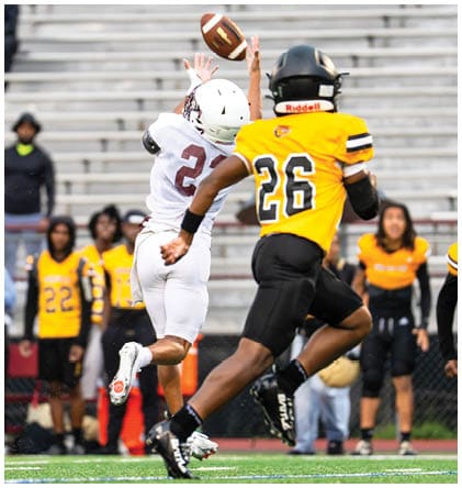 A football player wearing a blue and red jersey. Description generated by AI