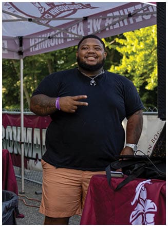 A football player wearing a blue and red jersey. Description generated by AI