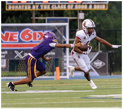 A football player running on the field. Description generated by AI