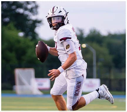 A football player running on the field. Description generated by AI