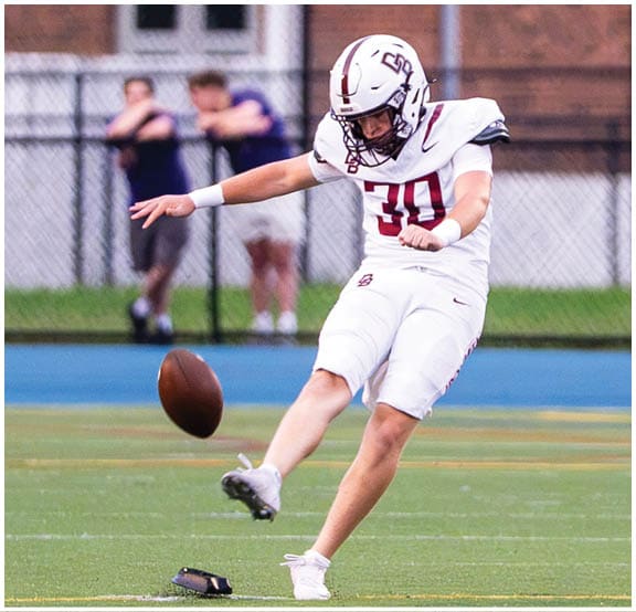 A football player wearing a blue and red jersey. Description generated by AI