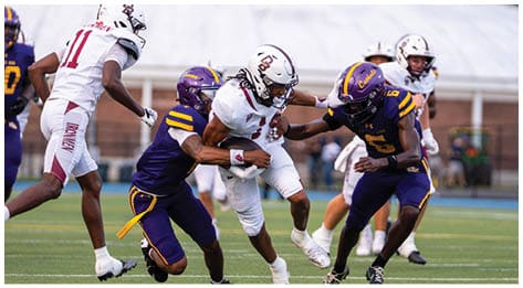 A football player wearing a blue and red jersey. Description generated by AI