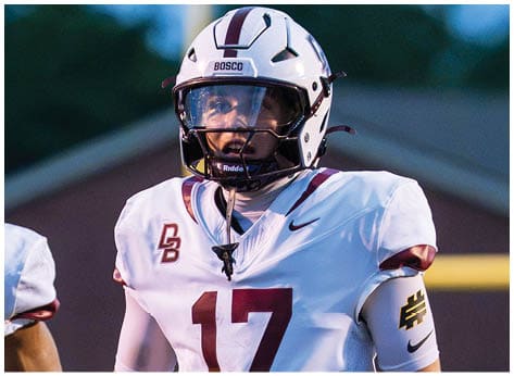 A football player wearing a blue and red jersey. Description generated by AI