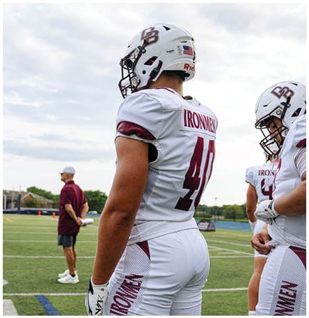 A football player wearing a blue and red jersey. Description generated by AI