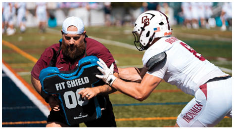 A football player wearing a blue and red jersey. Description generated by AI