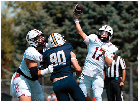 A football player wearing a blue and red jersey. Description generated by AI
